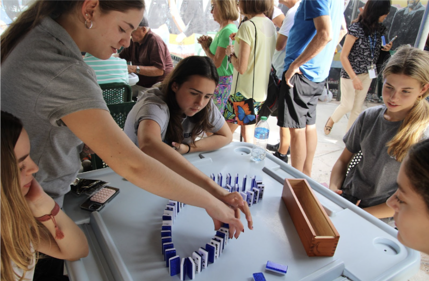 Students play a round of dominos in the Máximo Gómez Park. “It was my first time playing dominos and Im glad I got to learn it so that now I can play with my family and friends,” sophomore Isabel Mcginnis said.